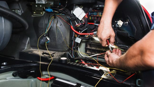 one of our team wiring a customers car